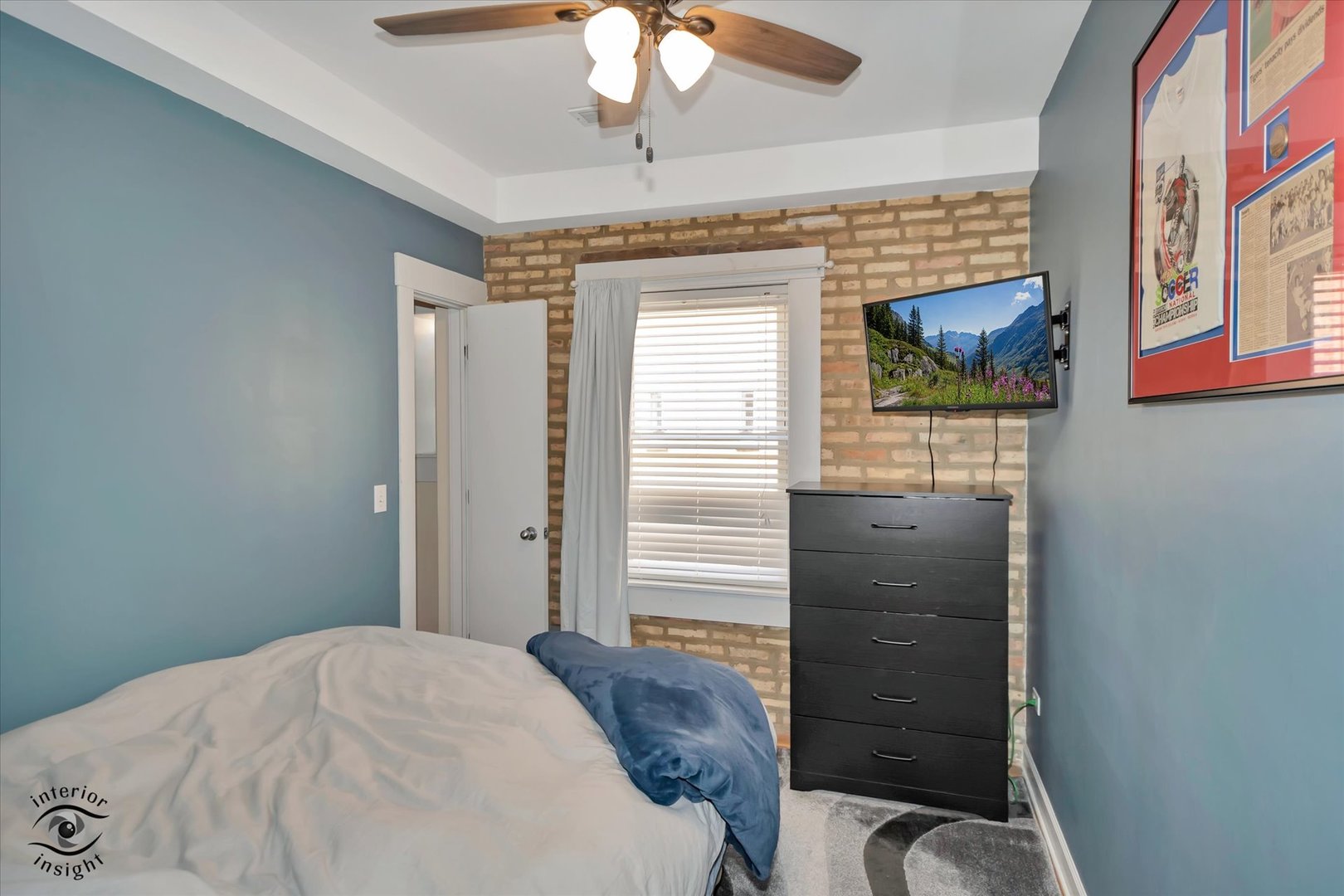 2537 Prairie Avenue, Unit 2E Evanston, IL 60201 - Photo 12 of 21 a bedroom with a bed and a chandelier