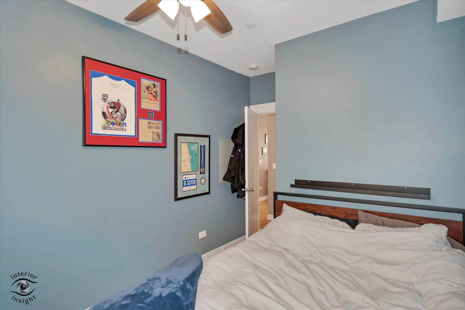 2537 Prairie Avenue, Unit 2E Evanston, IL 60201 - Photo 14 of 21 a bedroom with a bed and a chandelier
