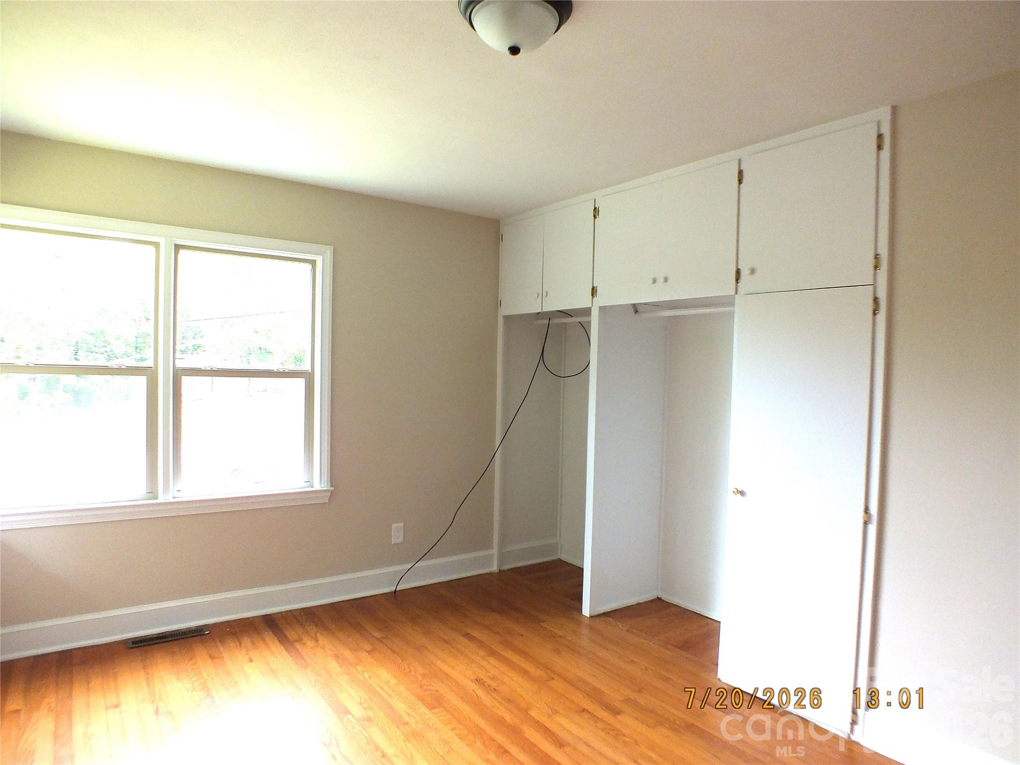 414 West Springs Street Lancaster, SC 29720 - Photo 11 of 22 a view of an empty room with wooden floor and a window