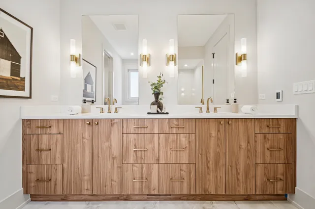 a bathroom with a granite countertop shower and a sink