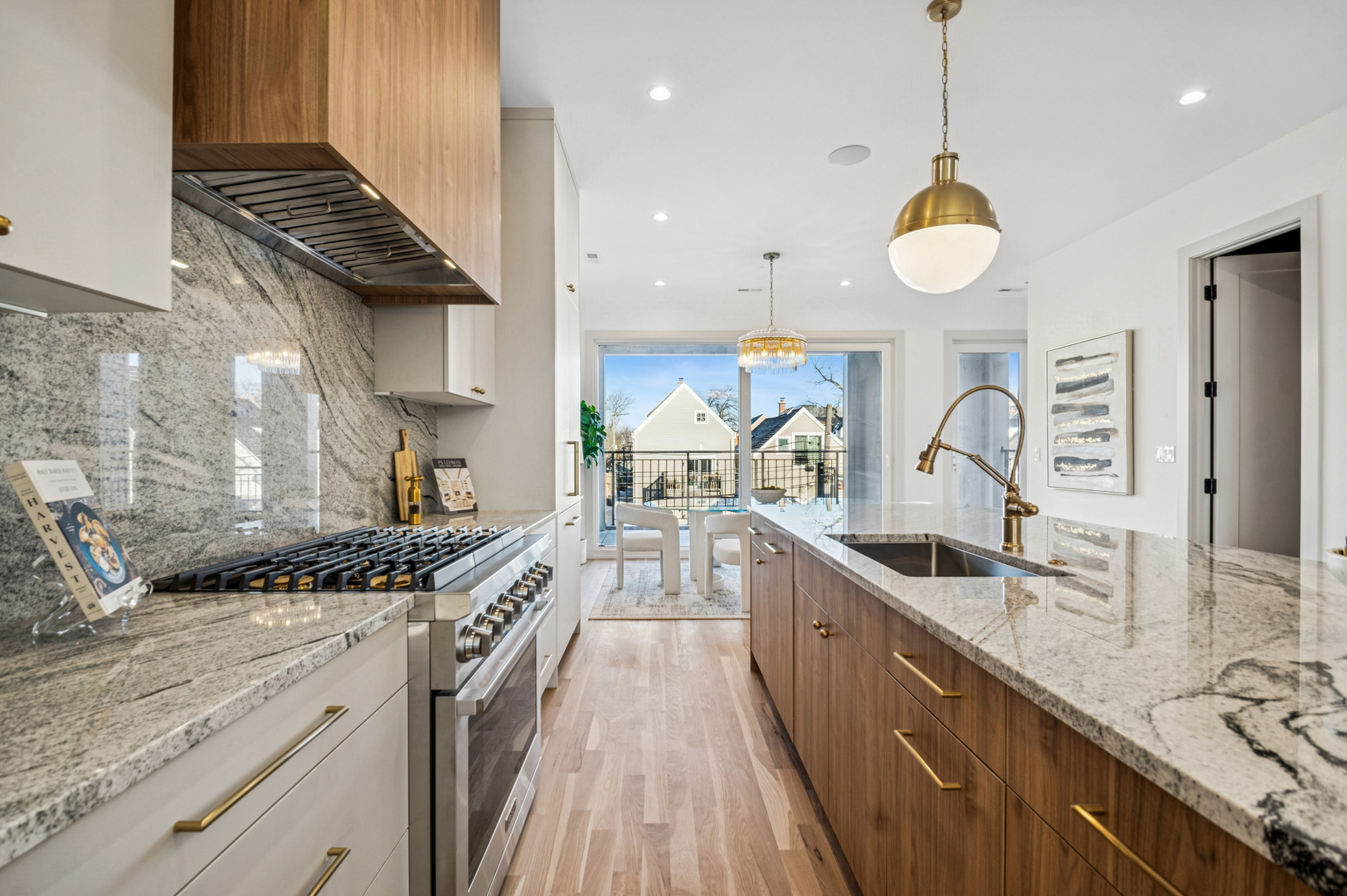 2246 West Lyndale Street, Unit 2 Chicago, IL 60647 - Photo 10 of 27 a kitchen with kitchen island granite countertop a stove a sink a counter space and cabinets