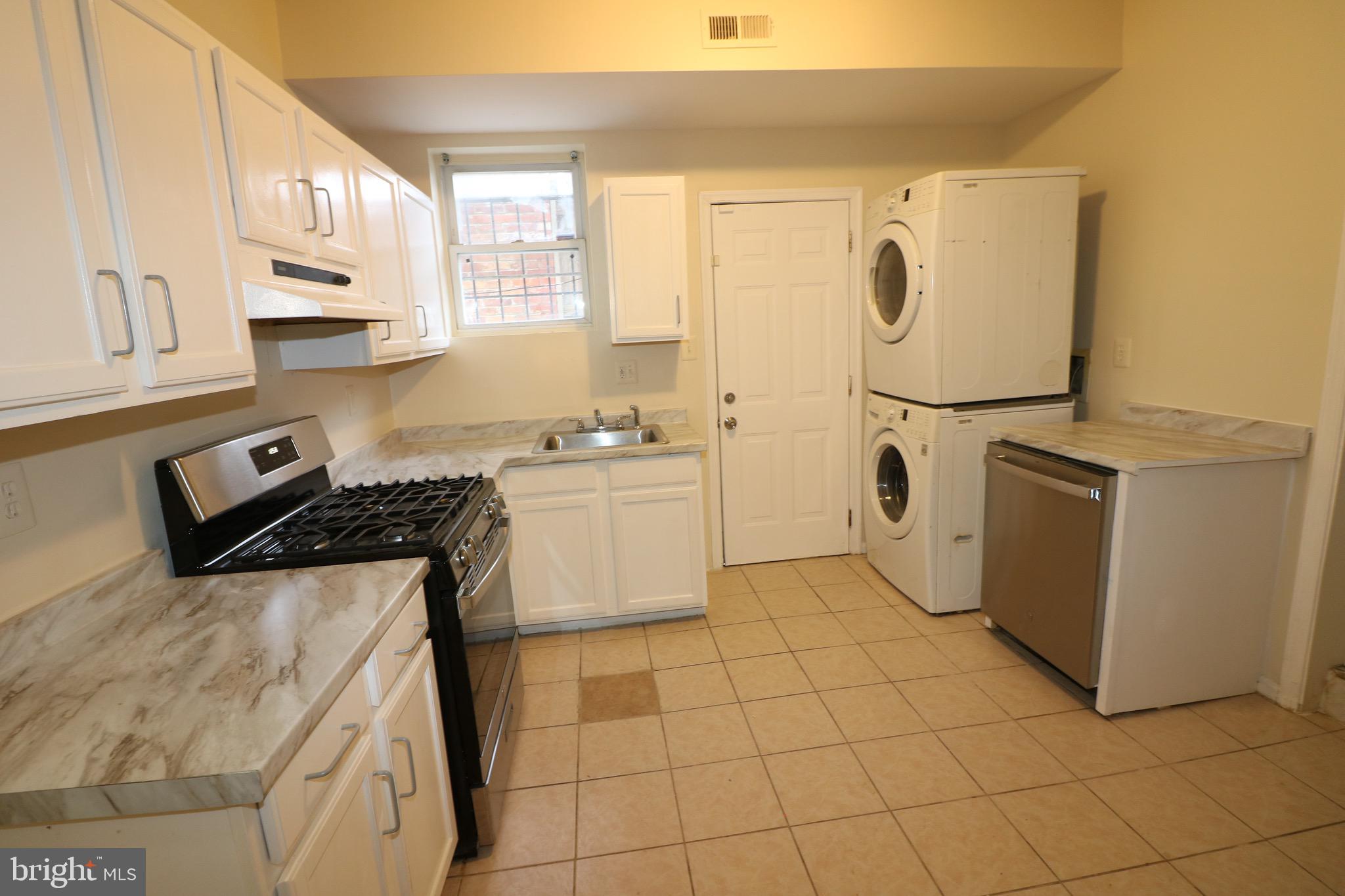 403 O Street Northwest Washington, DC 20001 - Photo 13 of 33 a kitchen with a sink a stove and white cabinets