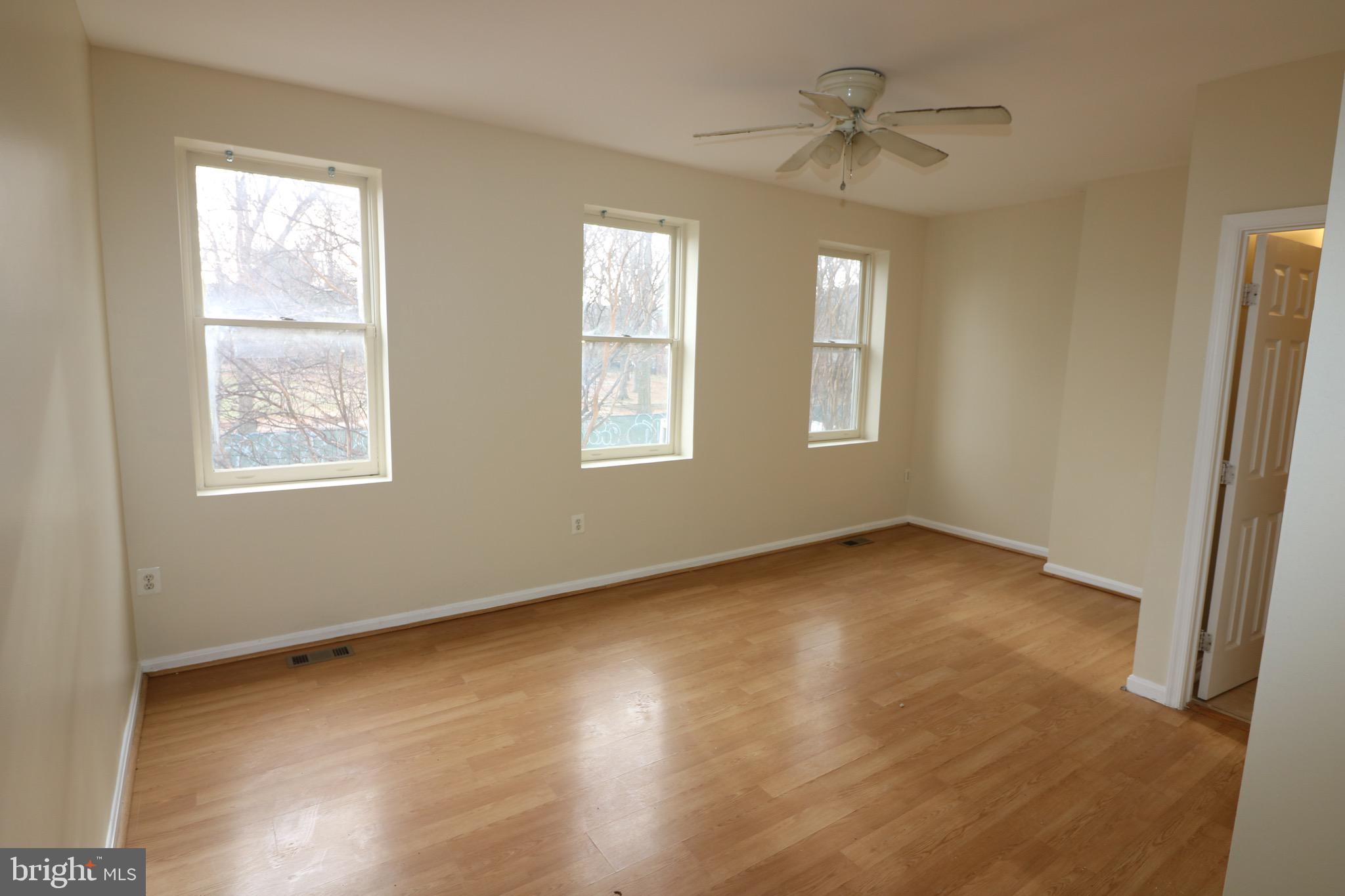 403 O Street Northwest Washington, DC 20001 - Photo 21 of 33 a view of an empty room with a window and wooden floor