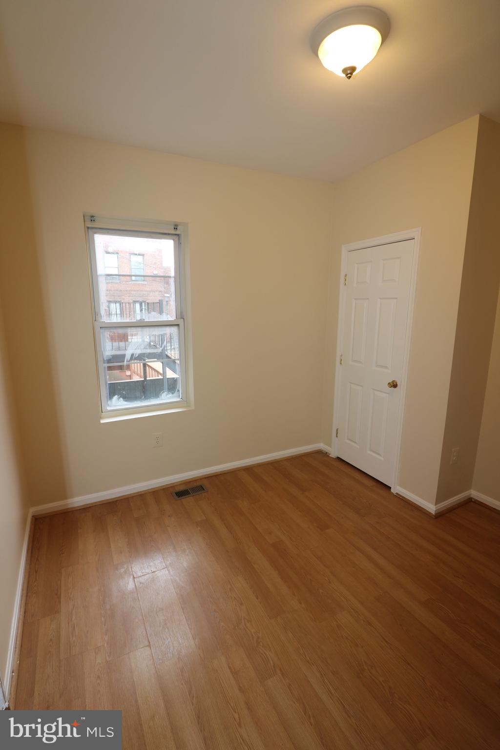 403 O Street Northwest Washington, DC 20001 - Photo 30 of 33 an empty room with wooden floor and windows
