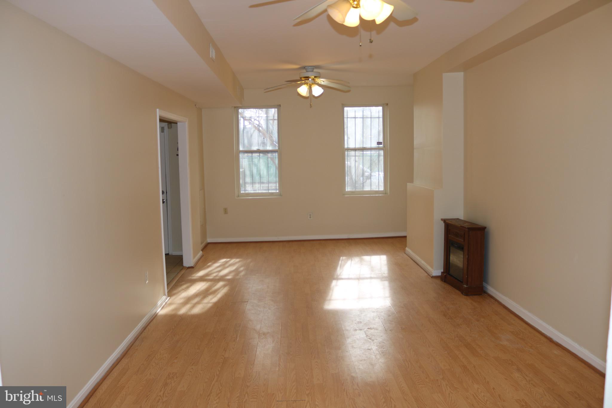 403 O Street Northwest Washington, DC 20001 - Photo 5 of 33 an empty room with wooden floor and windows