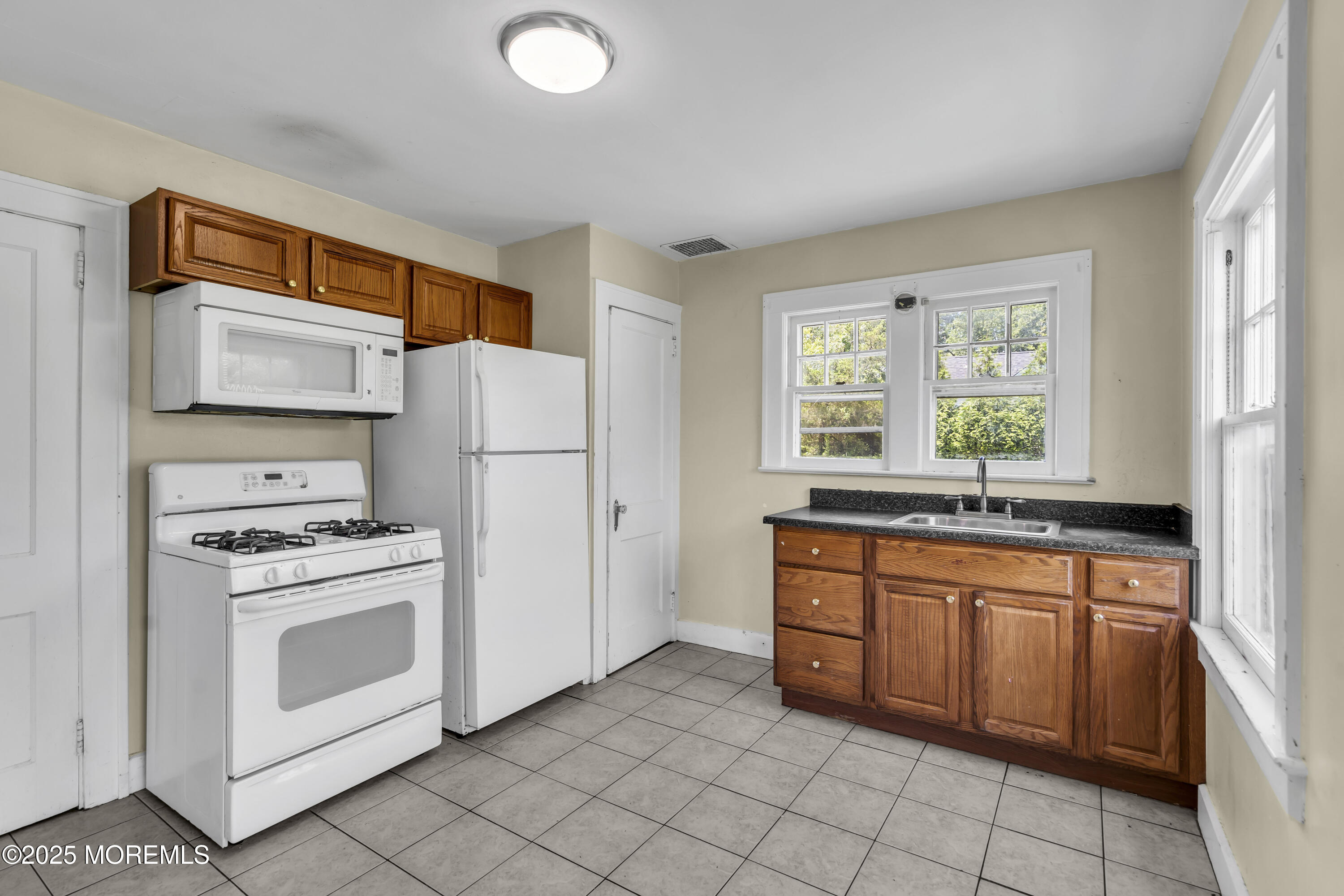189 Mantoloking Road Brick, NJ 08723 - Photo 12 of 38 a kitchen with stainless steel appliances granite countertop a stove a sink and a refrigerator