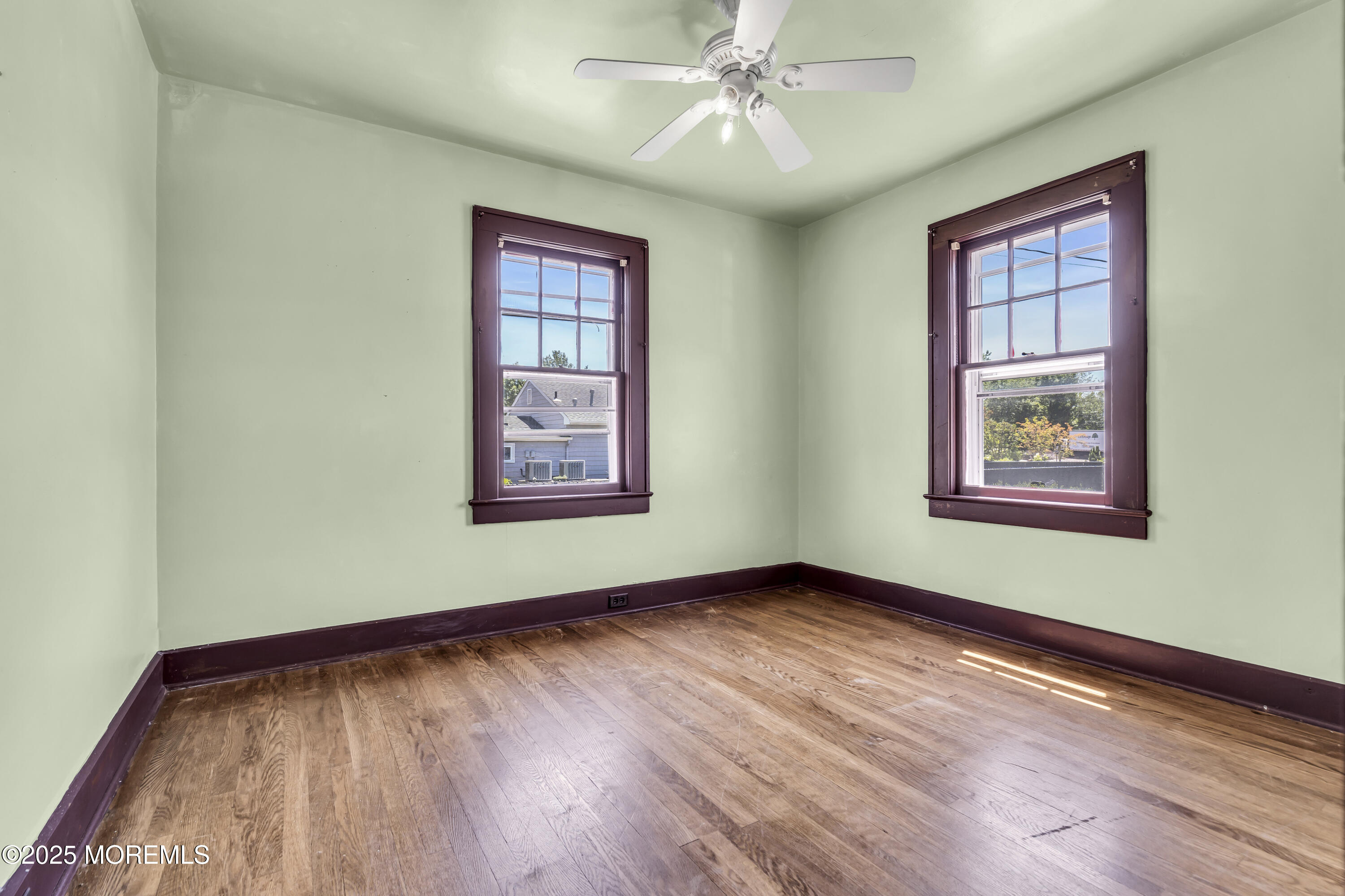 189 Mantoloking Road Brick, NJ 08723 - Photo 14 of 38 a view of an empty room with window and wooden floor