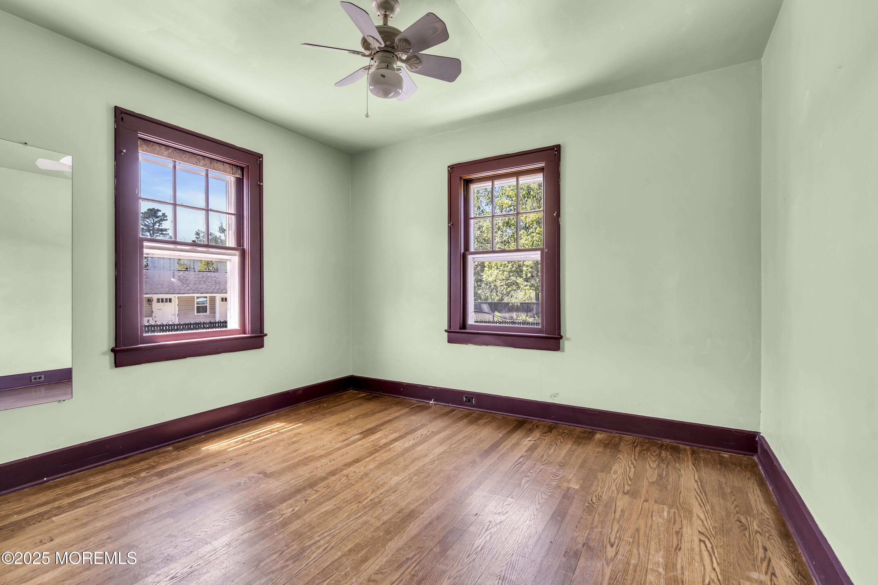 189 Mantoloking Road Brick, NJ 08723 - Photo 16 of 38 a view of an empty room with wooden floor and a window