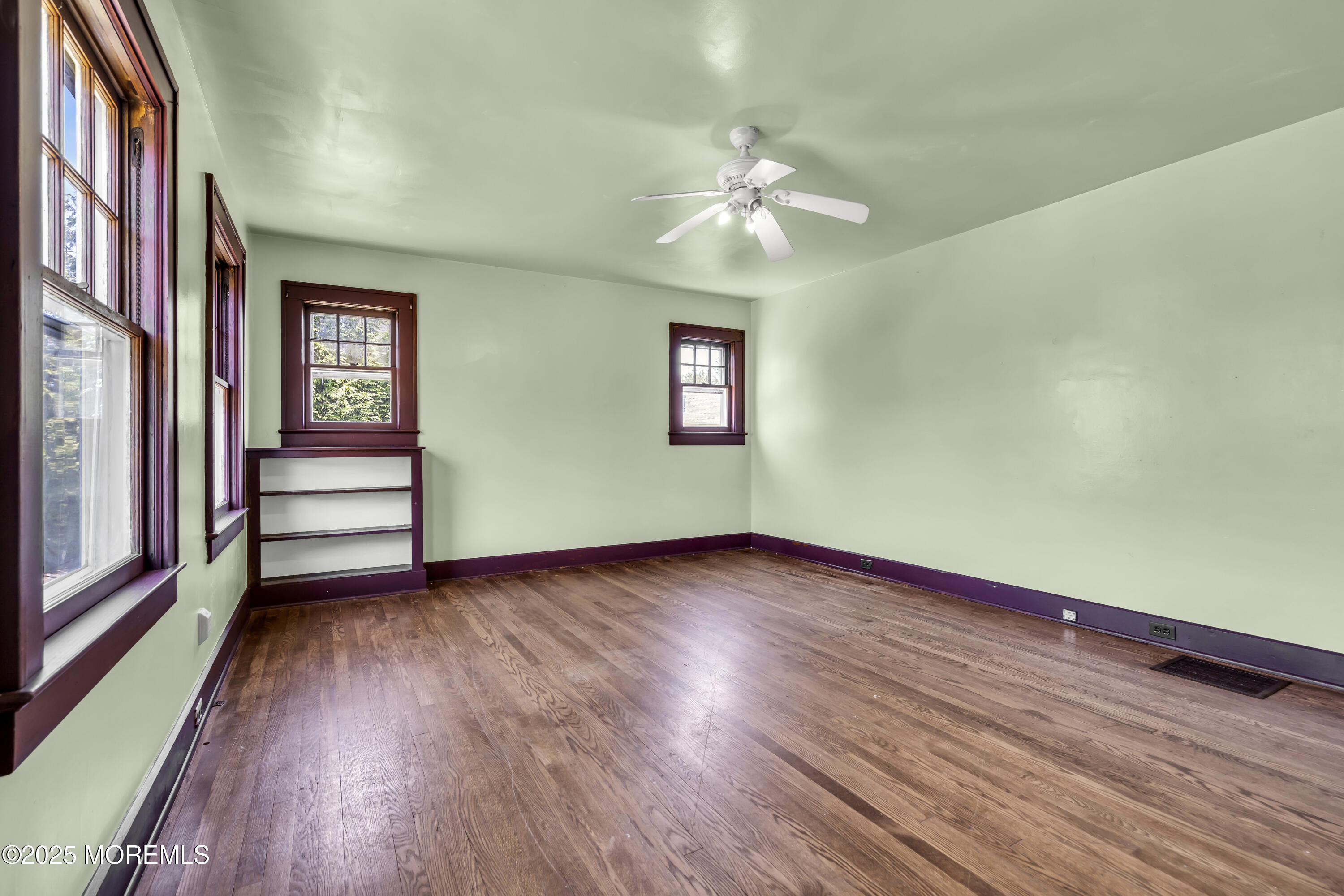189 Mantoloking Road Brick, NJ 08723 - Photo 6 of 38 a view of an empty room with wooden floor and a window