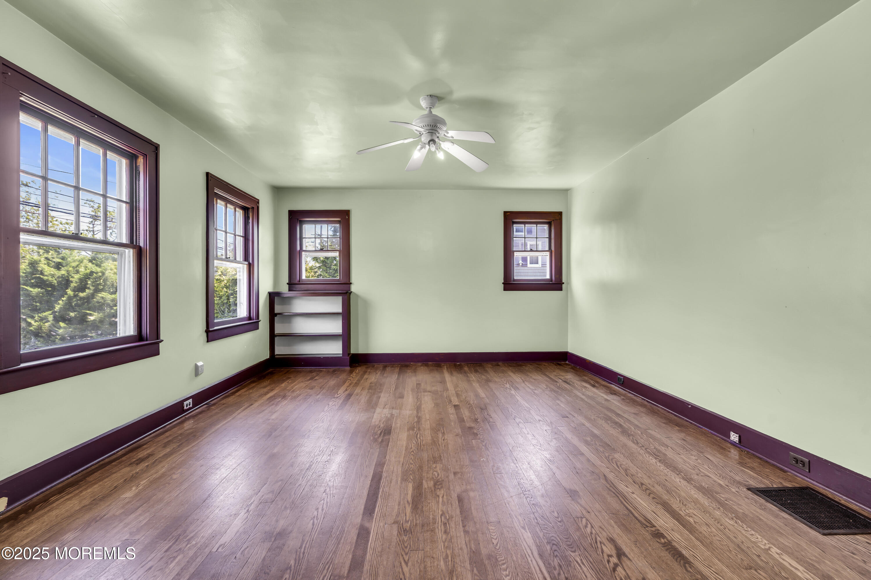 189 Mantoloking Road Brick, NJ 08723 - Photo 7 of 38 a view of an empty room window and wooden floor