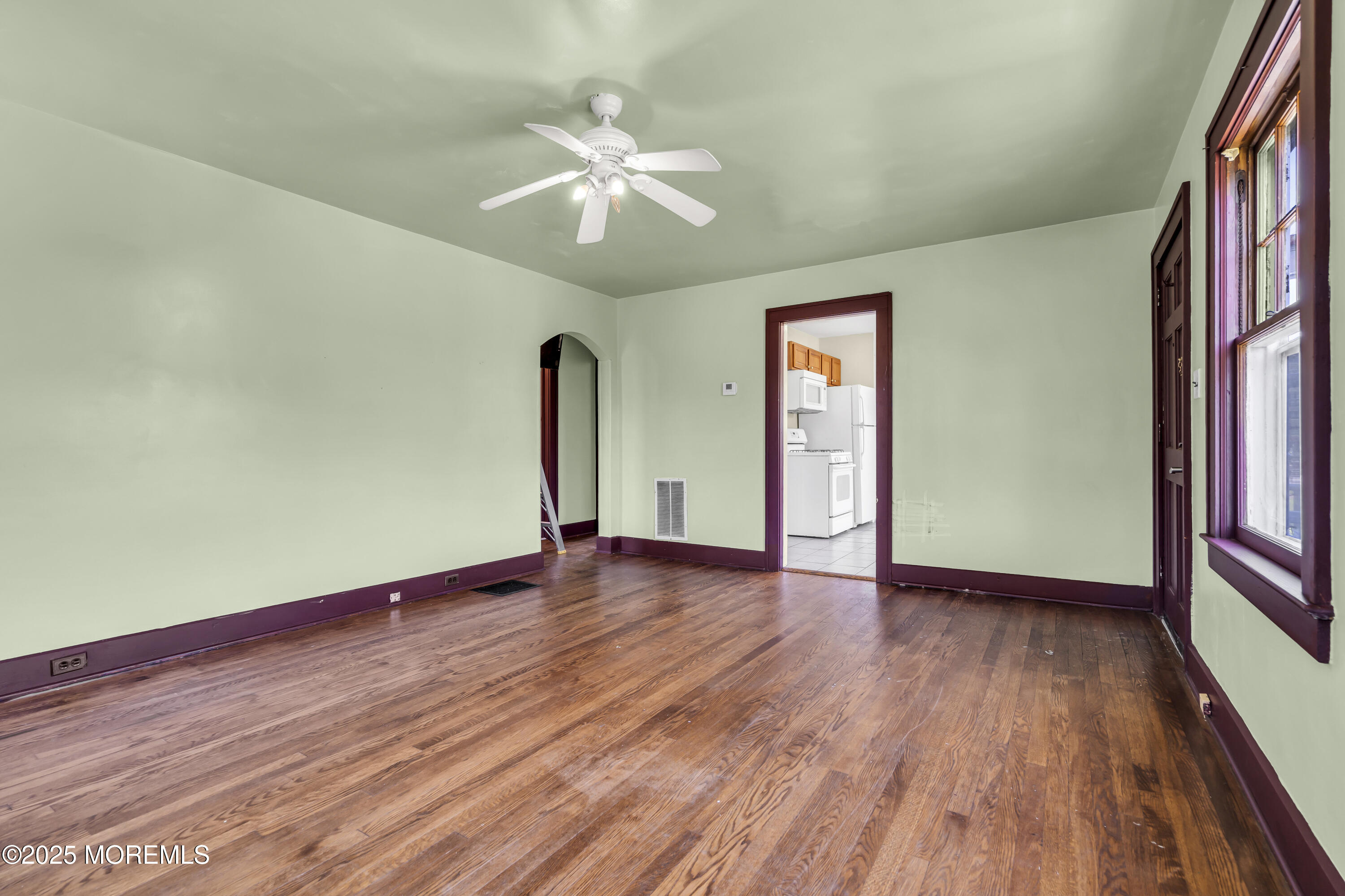 189 Mantoloking Road Brick, NJ 08723 - Photo 8 of 38 a view of an empty room with wooden floor and a window