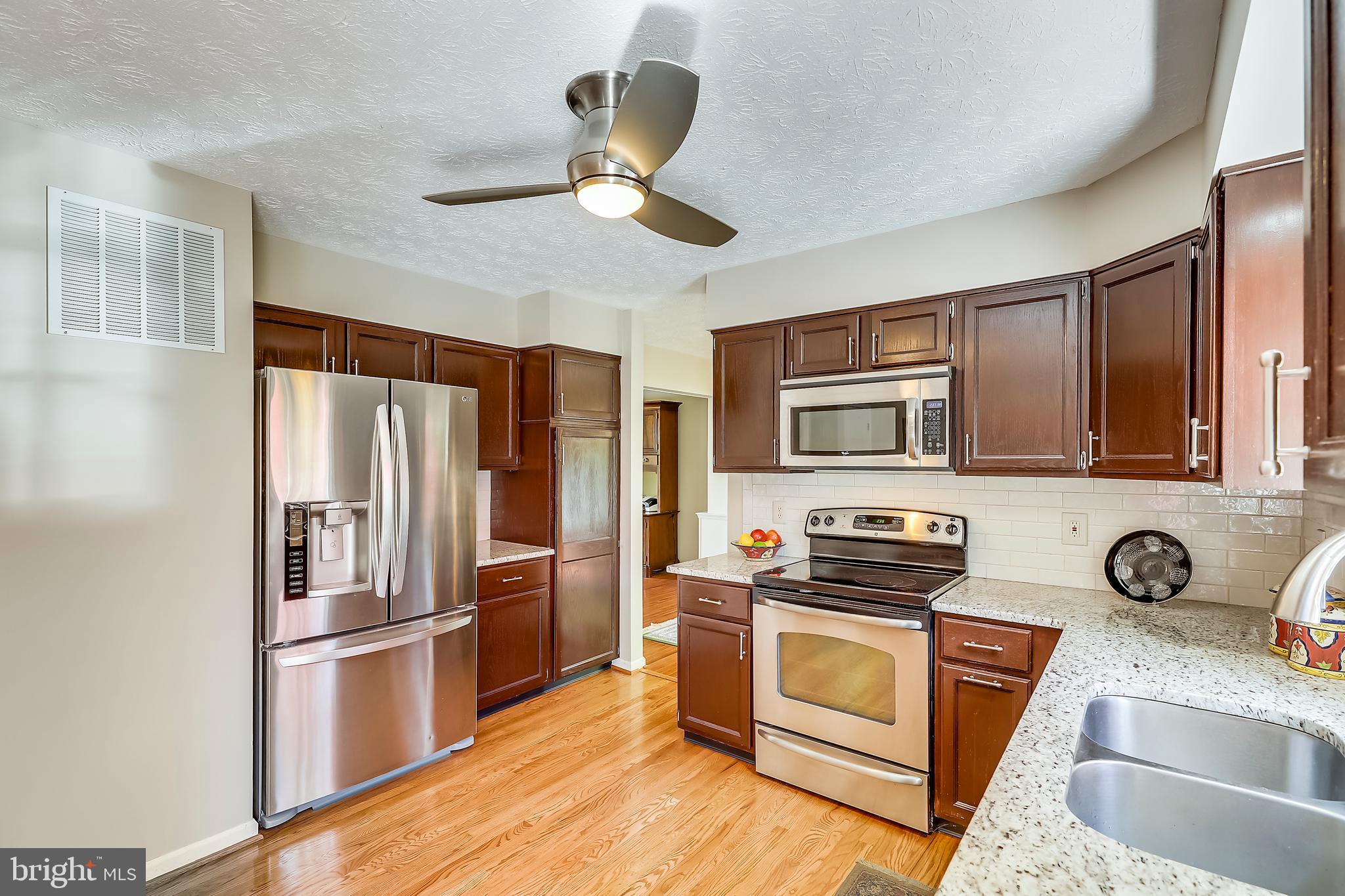 Granite and SS Kitchen w/ more hardwood flooring