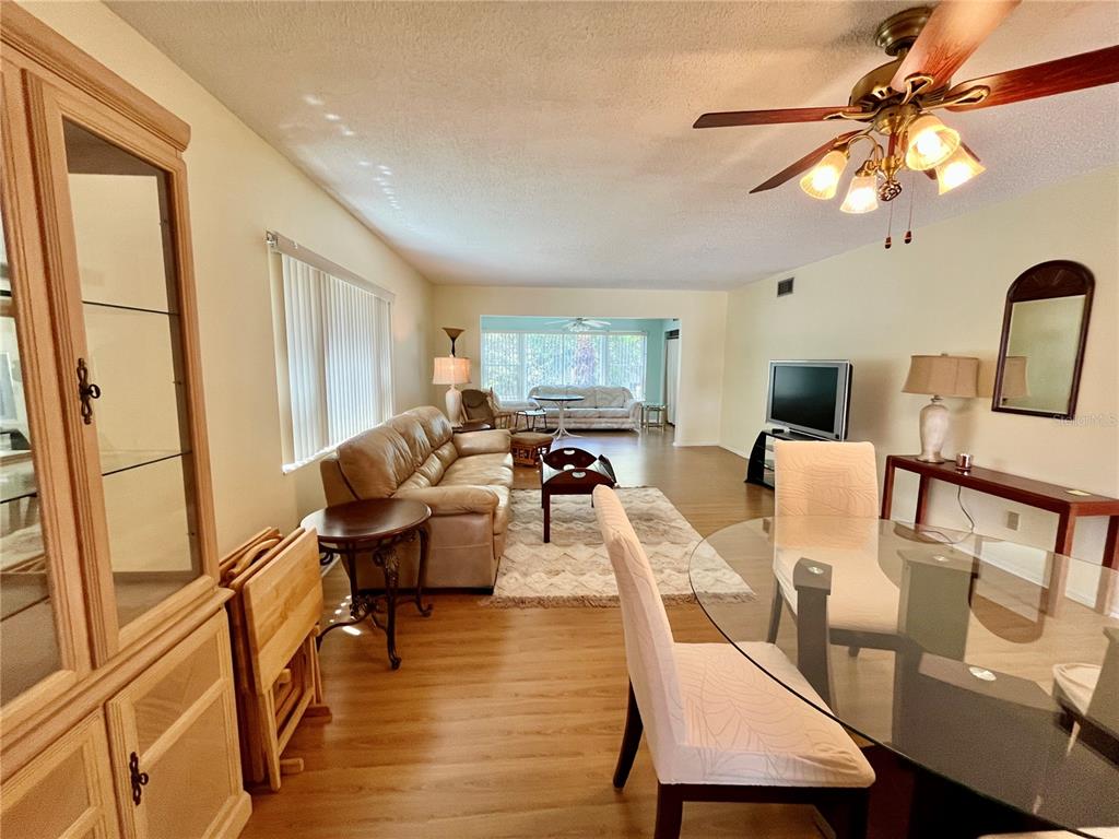 2292 Costa Rican Drive, Unit 22 Clearwater, FL 33763 - Photo 10 of 44 a living room with furniture dining table and a large window