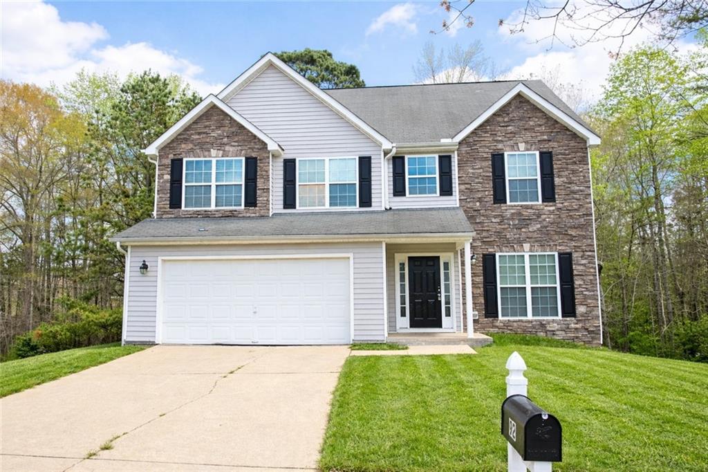 92 Revere Turn Fairburn, GA 30213 - Photo 1 of 42 a front view of a house with a yard and garage