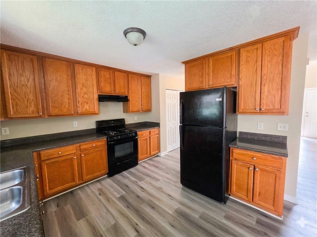 92 Revere Turn Fairburn, GA 30213 - Photo 11 of 42 a kitchen with granite countertop stainless steel appliances a refrigerator a stove a sink and a cabinets