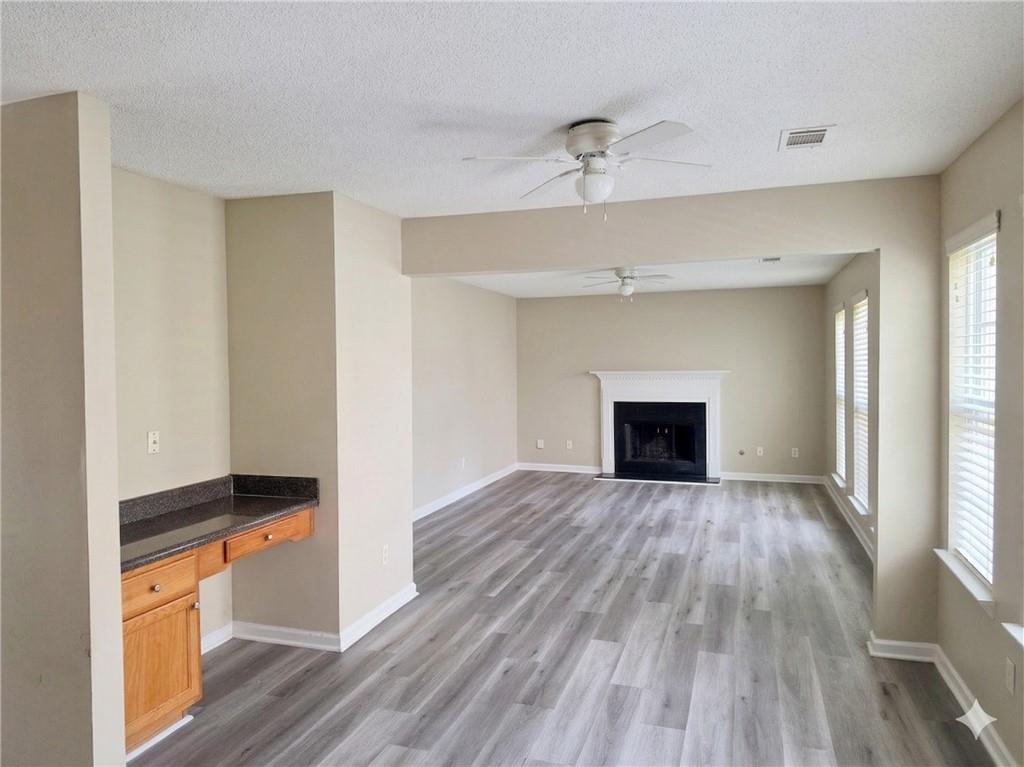 92 Revere Turn Fairburn, GA 30213 - Photo 12 of 42 a view of an empty room with wooden floor fireplace and a window