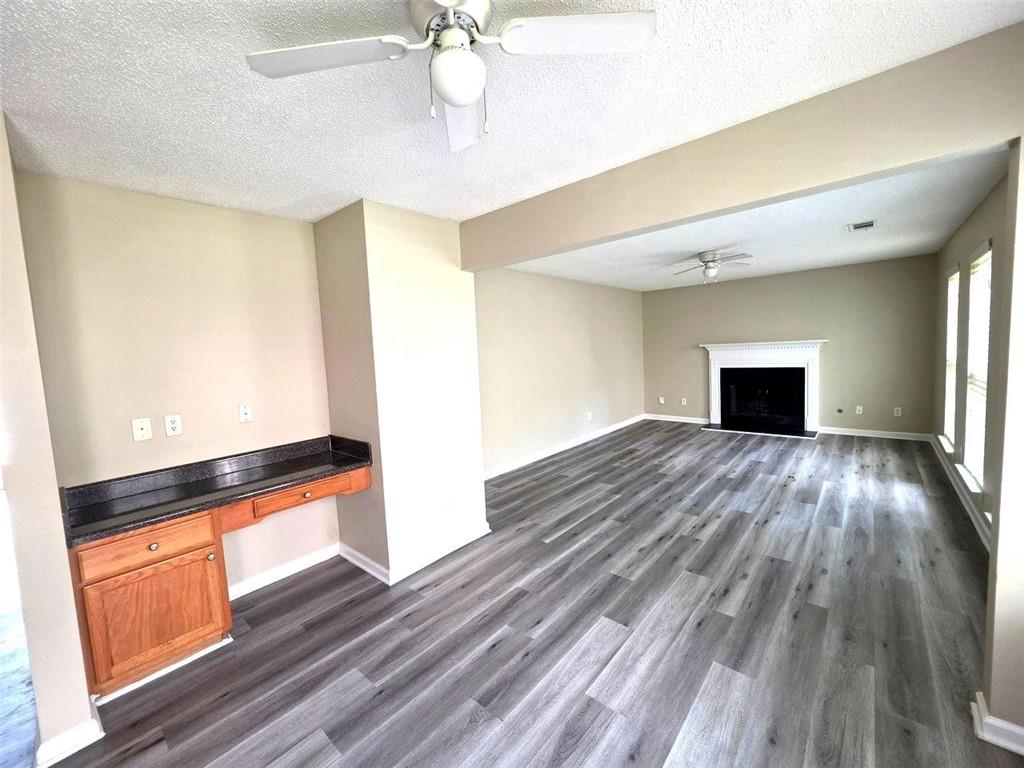 92 Revere Turn Fairburn, GA 30213 - Photo 13 of 42 a view of empty room with wooden floor