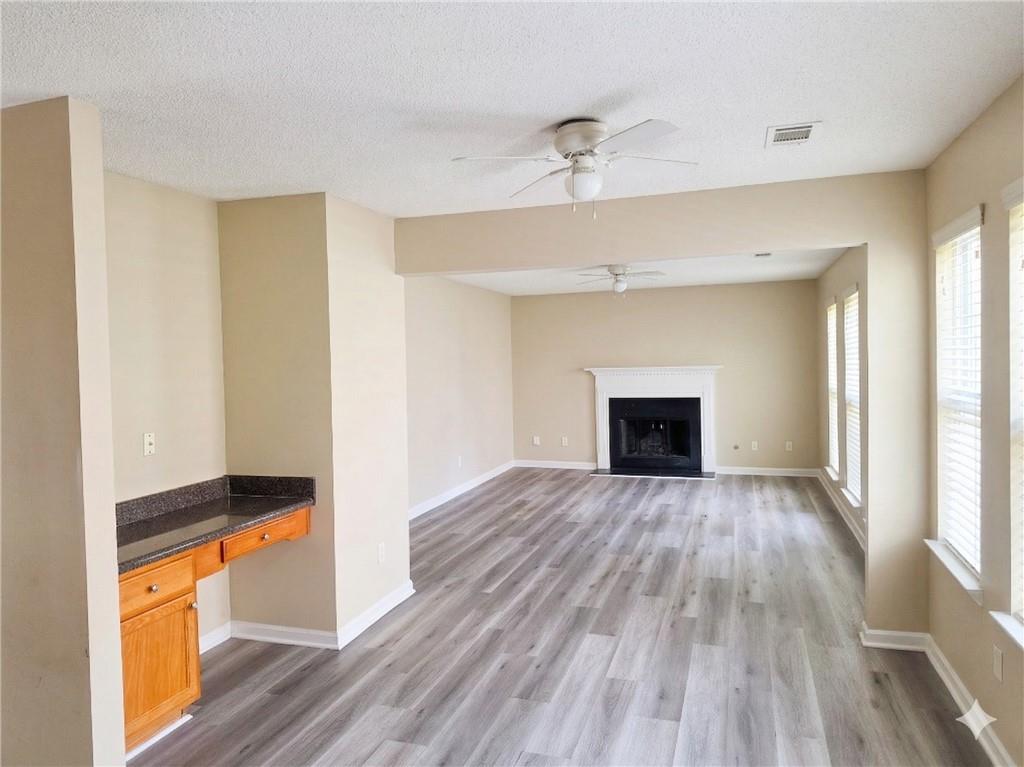 92 Revere Turn Fairburn, GA 30213 - Photo 16 of 42 a view of empty room with wooden floor and fireplace