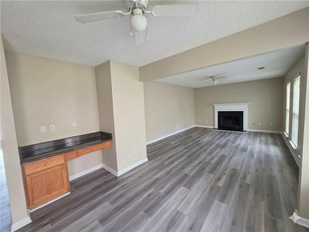 92 Revere Turn Fairburn, GA 30213 - Photo 17 of 42 wooden floor in an empty room with a window