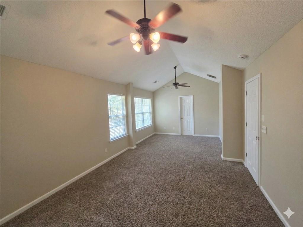 92 Revere Turn Fairburn, GA 30213 - Photo 18 of 42 a view of a big room with windows and chandelier fan