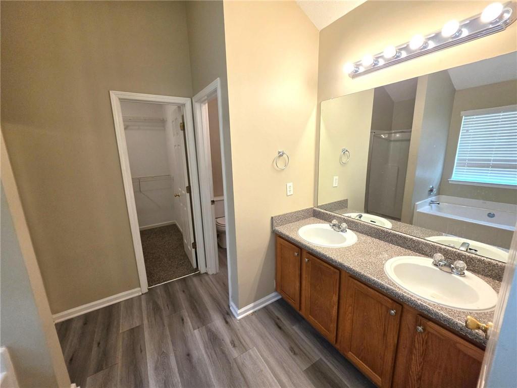 92 Revere Turn Fairburn, GA 30213 - Photo 20 of 42 a bathroom with a sink a mirror and a shower