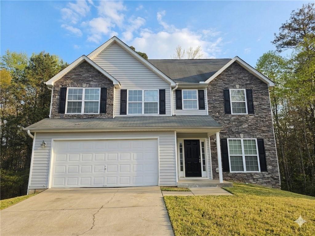 92 Revere Turn Fairburn, GA 30213 - Photo 2 of 42 a front view of a house with a yard and garage