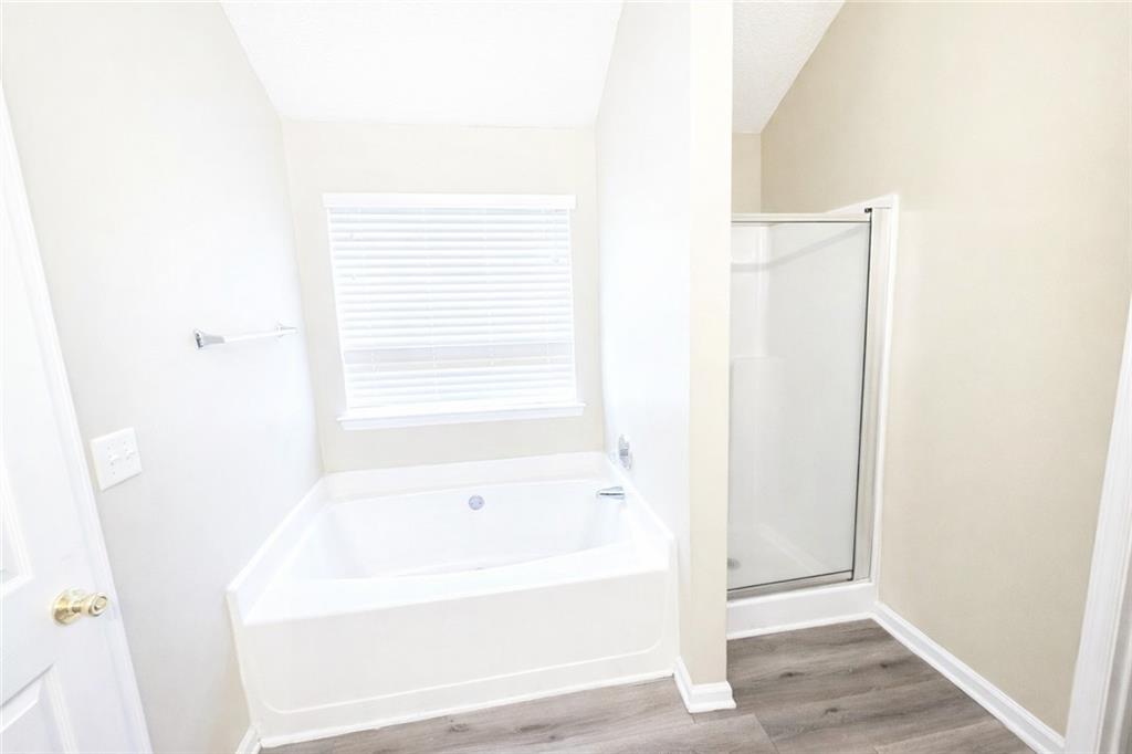 92 Revere Turn Fairburn, GA 30213 - Photo 22 of 42 a bathroom with a bathtub