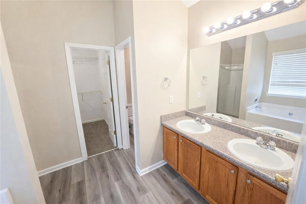 92 Revere Turn Fairburn, GA 30213 - Photo 23 of 42 a bathroom with a sink a mirror and a shower
