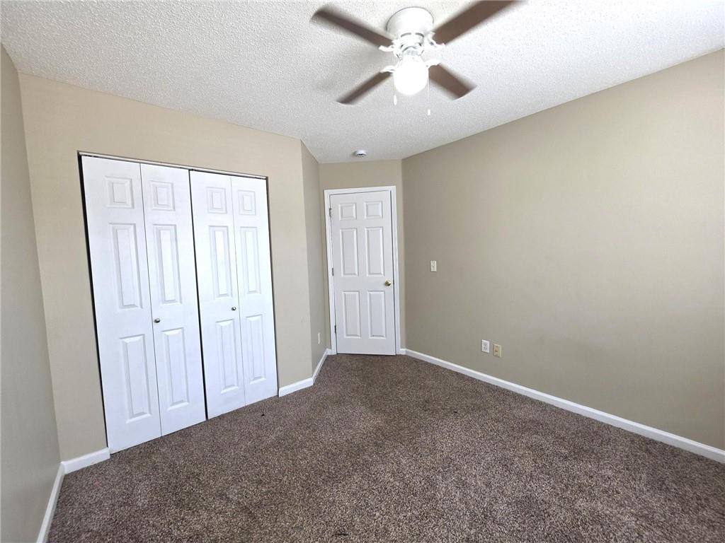 92 Revere Turn Fairburn, GA 30213 - Photo 26 of 42 an empty room with a ceiling fan and a window