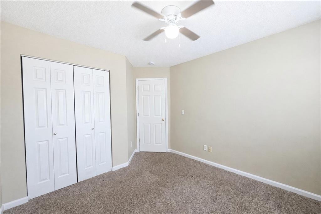 92 Revere Turn Fairburn, GA 30213 - Photo 28 of 42 a view of a big room with closet and a chandelier fan