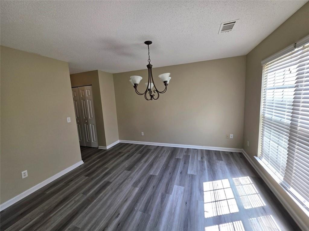 92 Revere Turn Fairburn, GA 30213 - Photo 3 of 42 a view of an empty room with wooden floor and windows