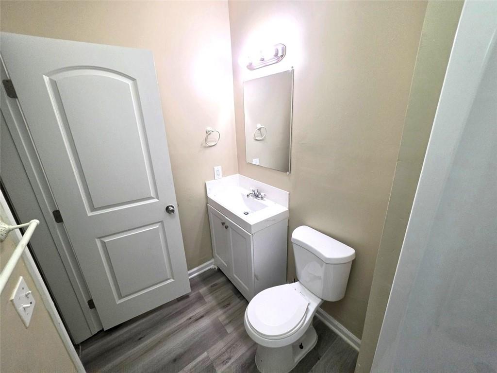 92 Revere Turn Fairburn, GA 30213 - Photo 38 of 42 a white toilet sitting next to a white sink and vanity