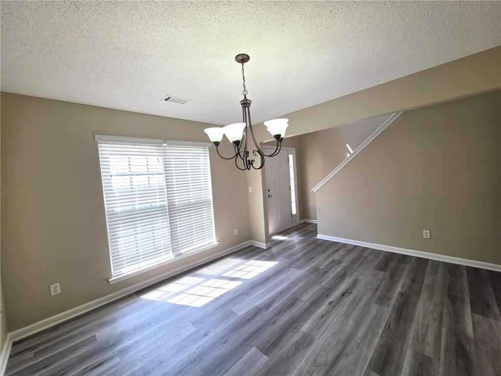 92 Revere Turn Fairburn, GA 30213 - Photo 4 of 42 a view of an empty room with wooden floor and a window