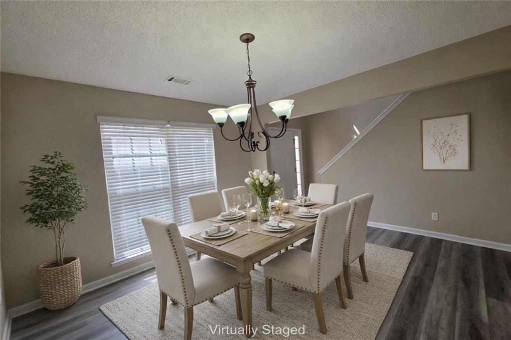 92 Revere Turn Fairburn, GA 30213 - Photo 5 of 42 a view of a dining room with furniture window and wooden floor