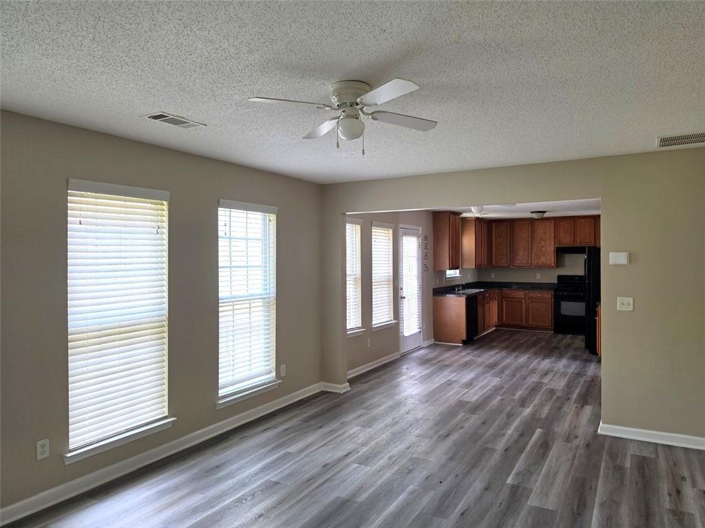 92 Revere Turn Fairburn, GA 30213 - Photo 9 of 42 a view of an empty room with wooden floor and a window