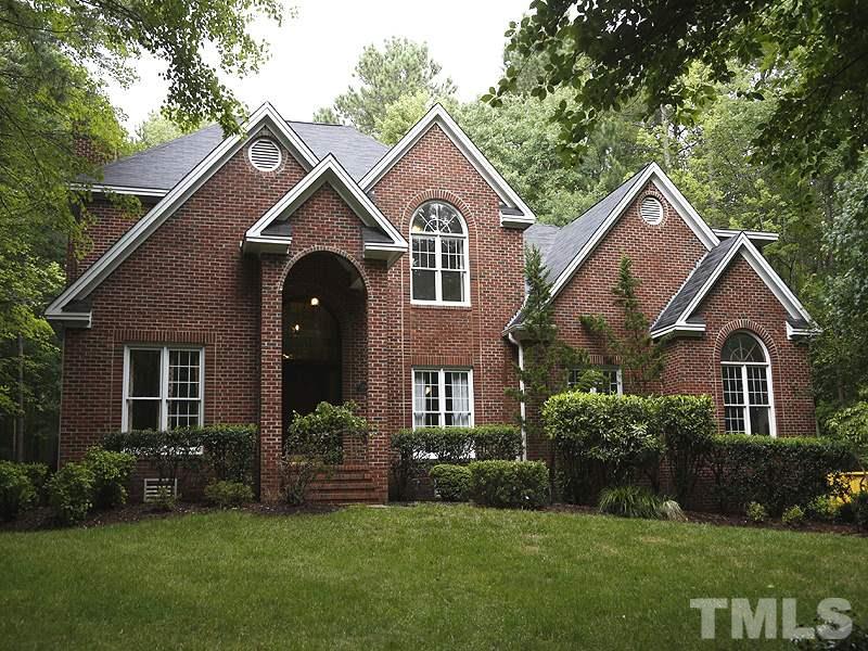 12317 Glenlivet Way Raleigh, NC 27613 - Photo 1 of 25 a front view of a house with a garden and plants