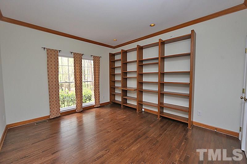 12317 Glenlivet Way Raleigh, NC 27613 - Photo 12 of 25 wooden floor in an empty room with a window