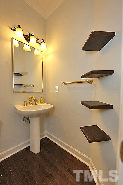 12317 Glenlivet Way Raleigh, NC 27613 - Photo 13 of 25 a bathroom with a sink a mirror and toilet