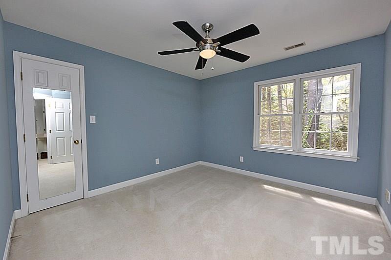 12317 Glenlivet Way Raleigh, NC 27613 - Photo 20 of 25 an empty room with windows and fan