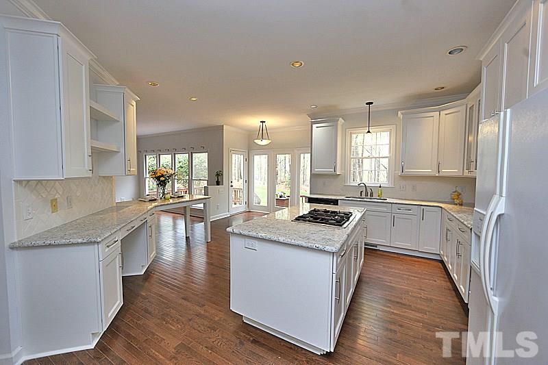 12317 Glenlivet Way Raleigh, NC 27613 - Photo 5 of 25 a kitchen with a stove a sink and a refrigerator