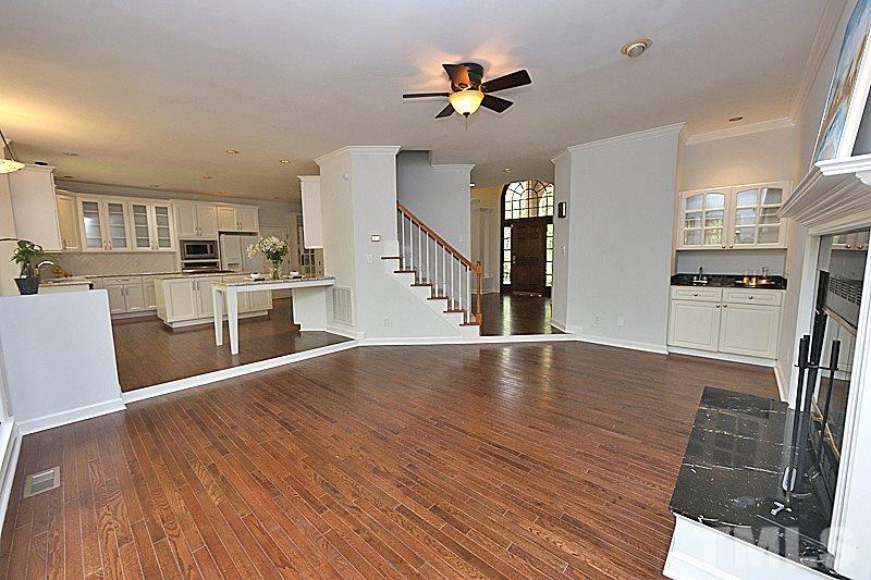 12317 Glenlivet Way Raleigh, NC 27613 - Photo 10 of 25 a view of a kitchen with stove and wooden floor