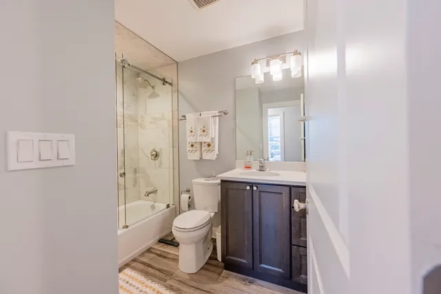 a spacious bathroom with a toilet sink and shower