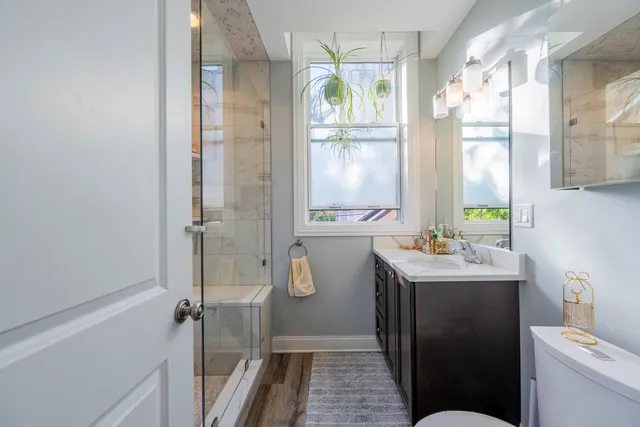 a bathroom with a sink a toilet and shower