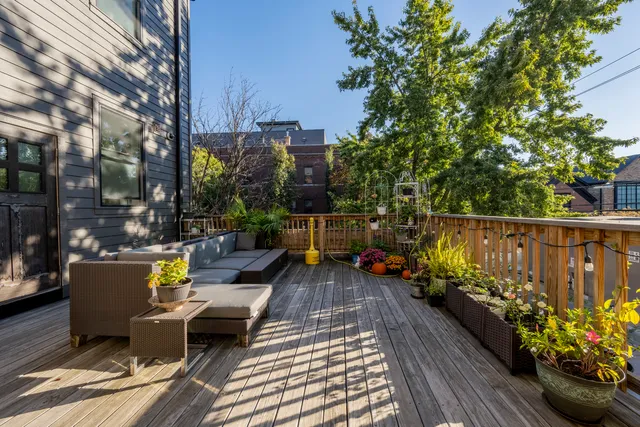 a view of a balcony with wooden chairs