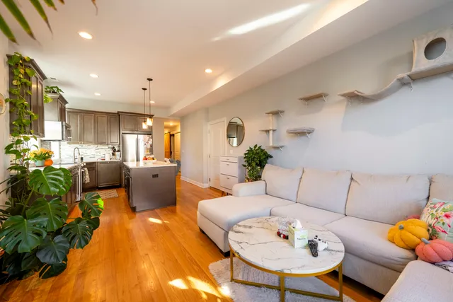 a living room with furniture kitchen and a table