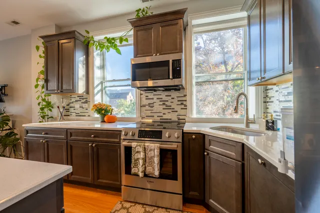 a kitchen with stainless steel appliances a stove sink and microwave