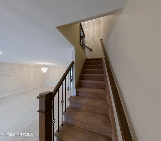 a bathroom with a granite countertop sink toilet and mirror