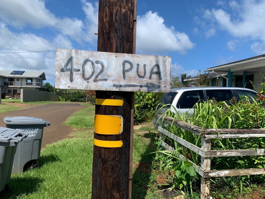 402 Pua Road, Unit 1 Kapaa, HI 96746 - Photo 14 of 14 a view of sign board with yard and buildings in the background