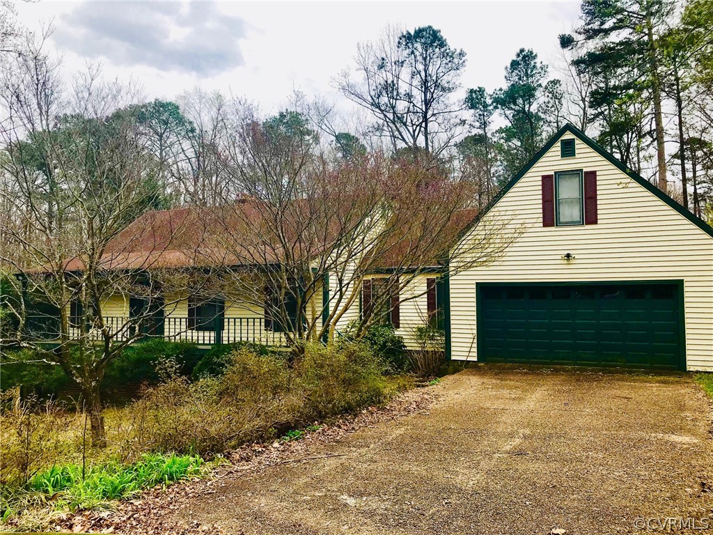 3411 Wood Dale Road Chester, VA 23831 - Photo 1 of 6 a front view of a house with a yard and garage