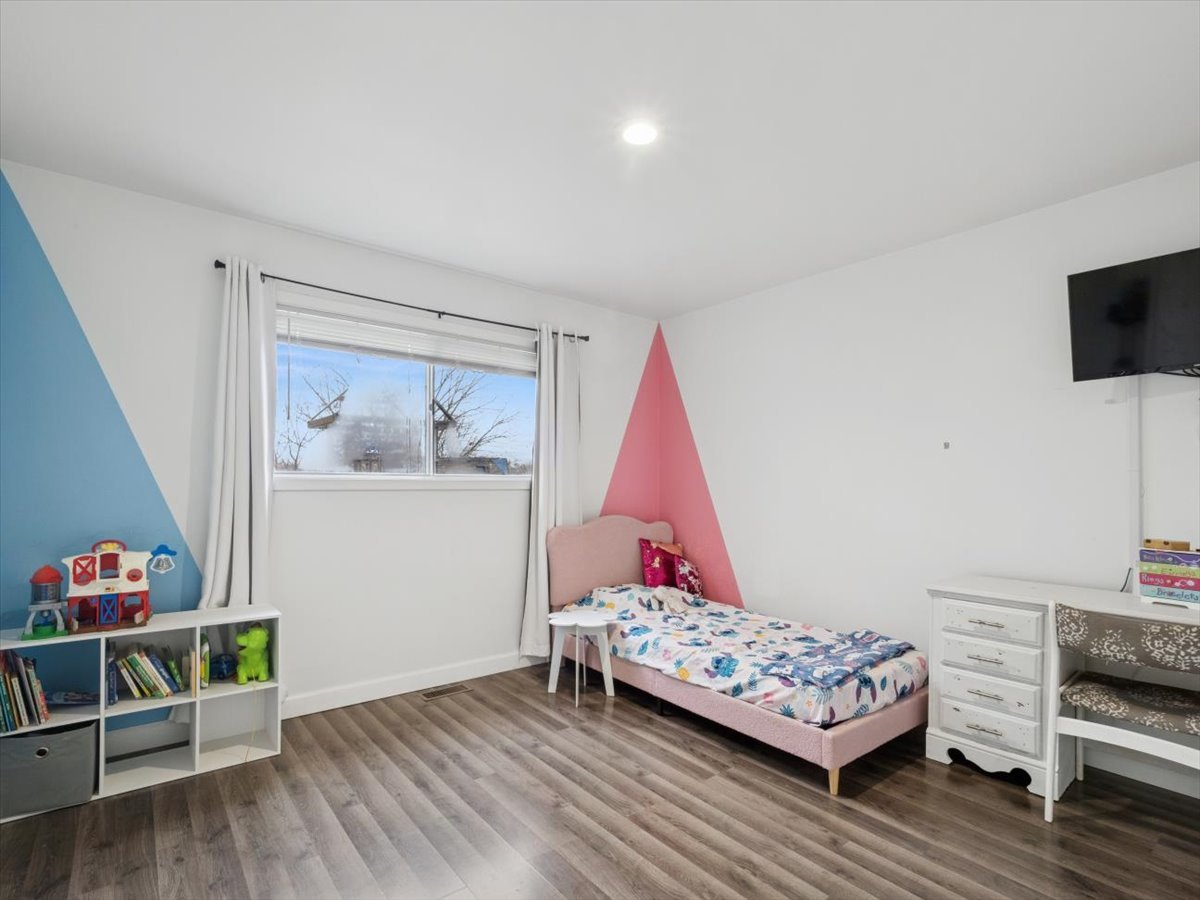 1220 Fulton Drive Streamwood, IL 60107 - Photo 13 of 18 a bedroom with a bed and a wooden floor